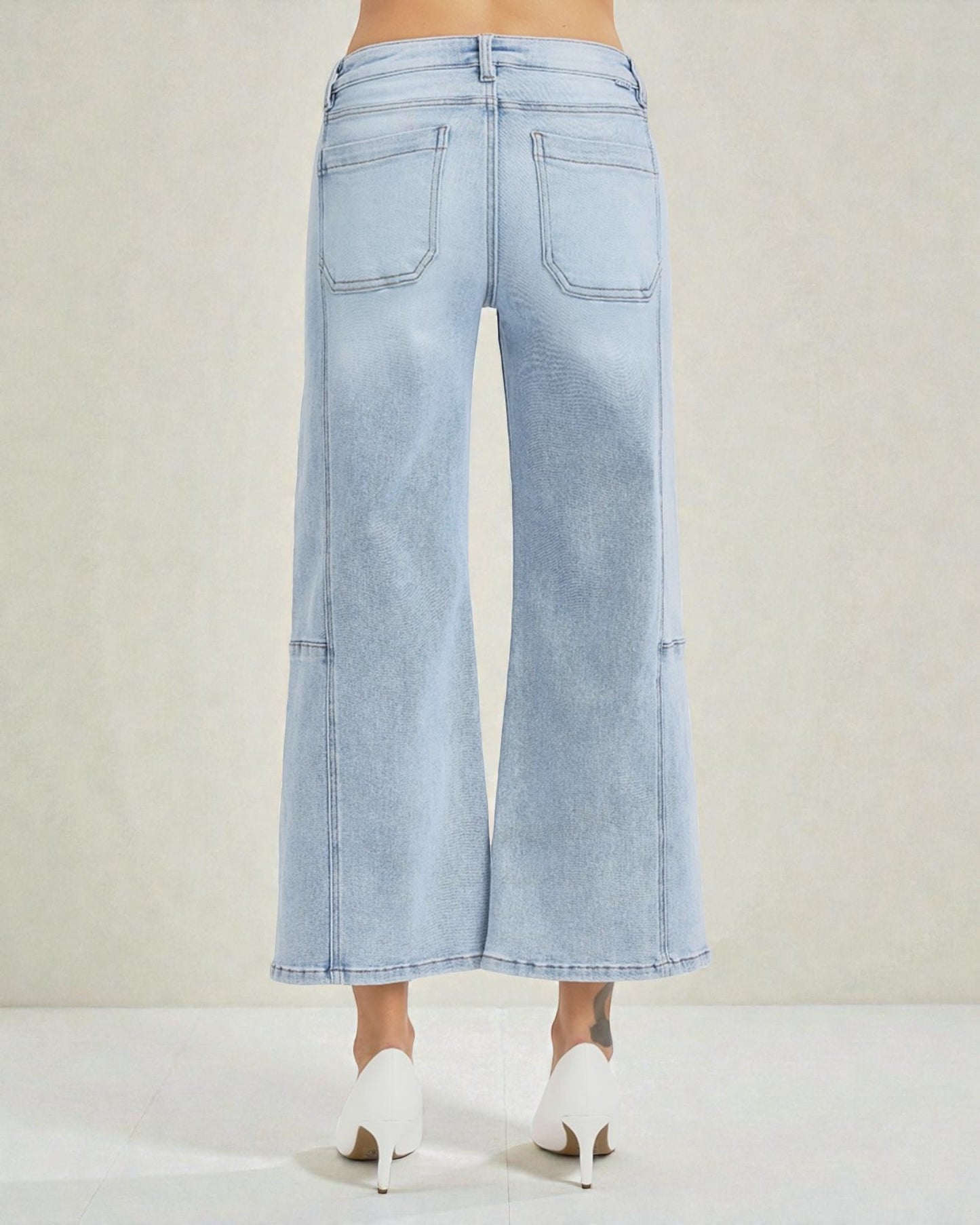 Light blue wide-leg jeans worn by a person on a white background