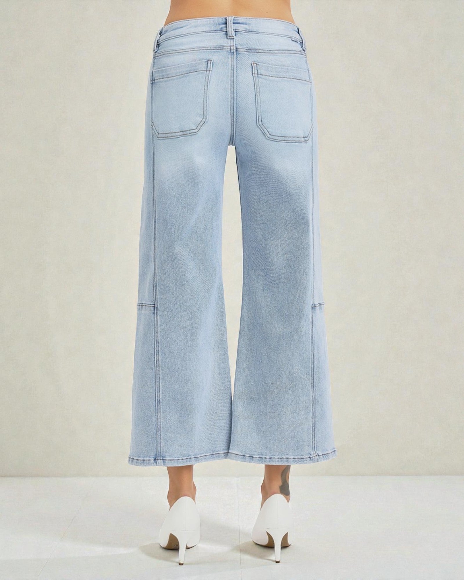 Light blue wide-leg jeans worn by a person on a white background