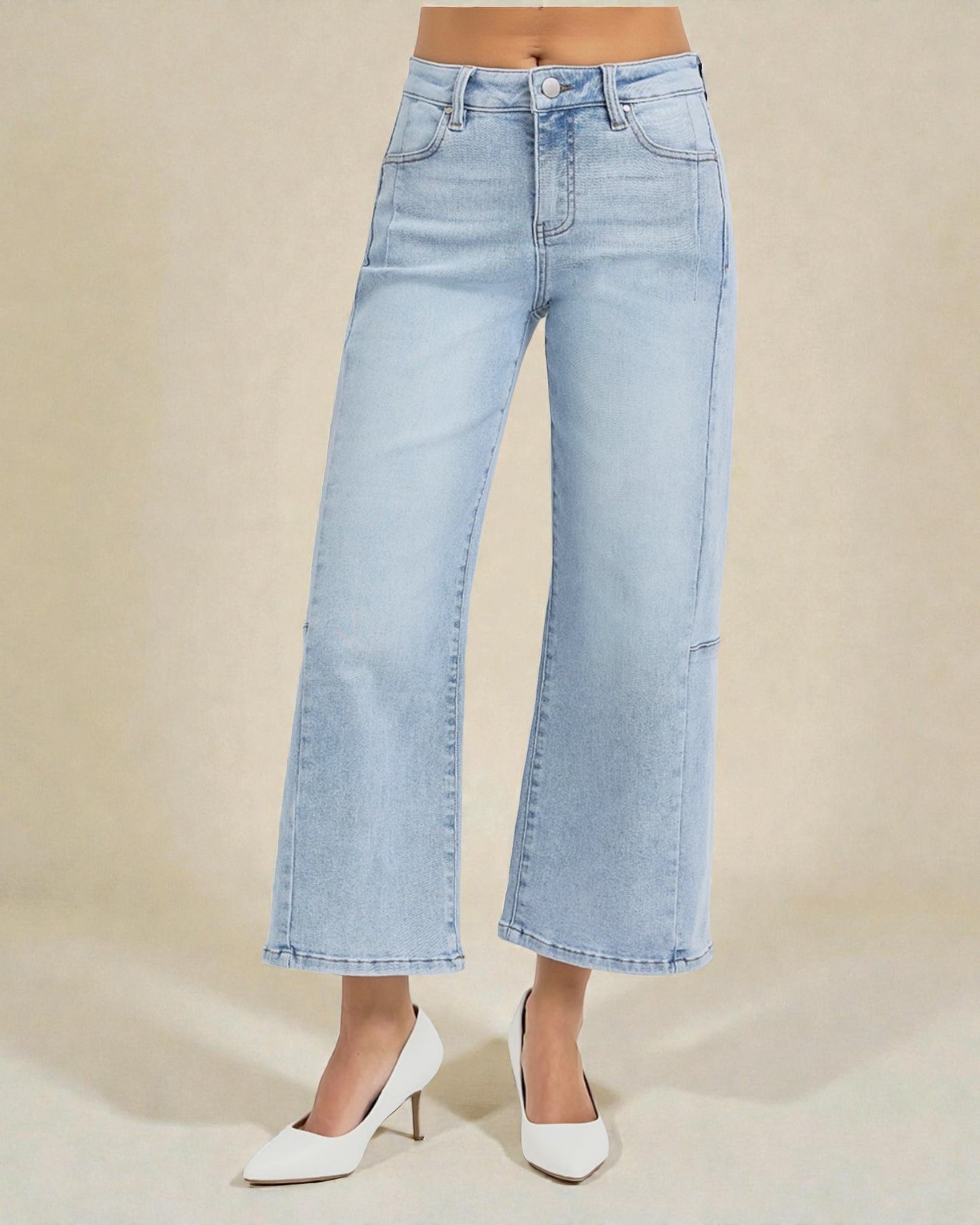 Light blue wide-leg jeans worn by a person on a beige background