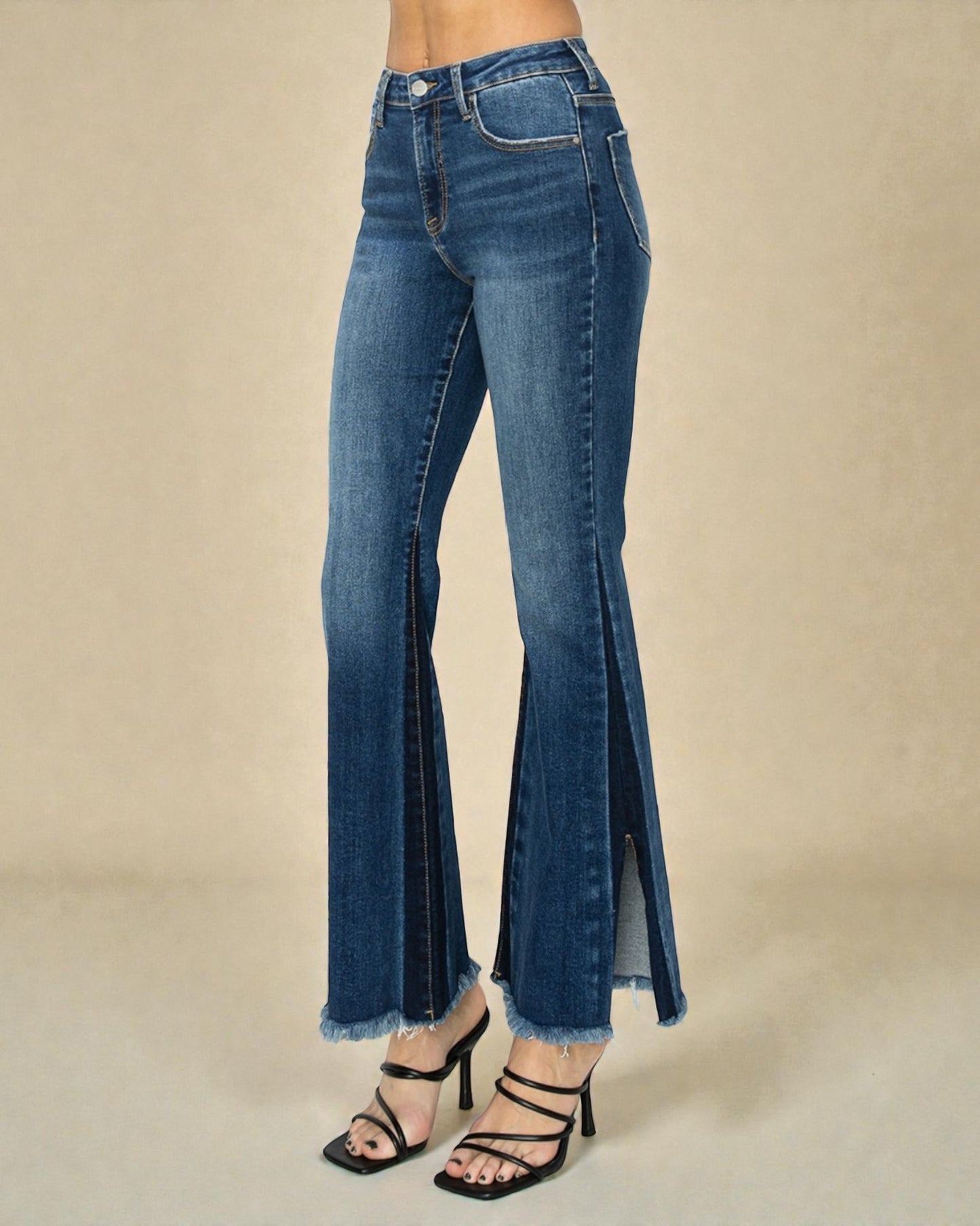 Blue flared jeans on a beige background