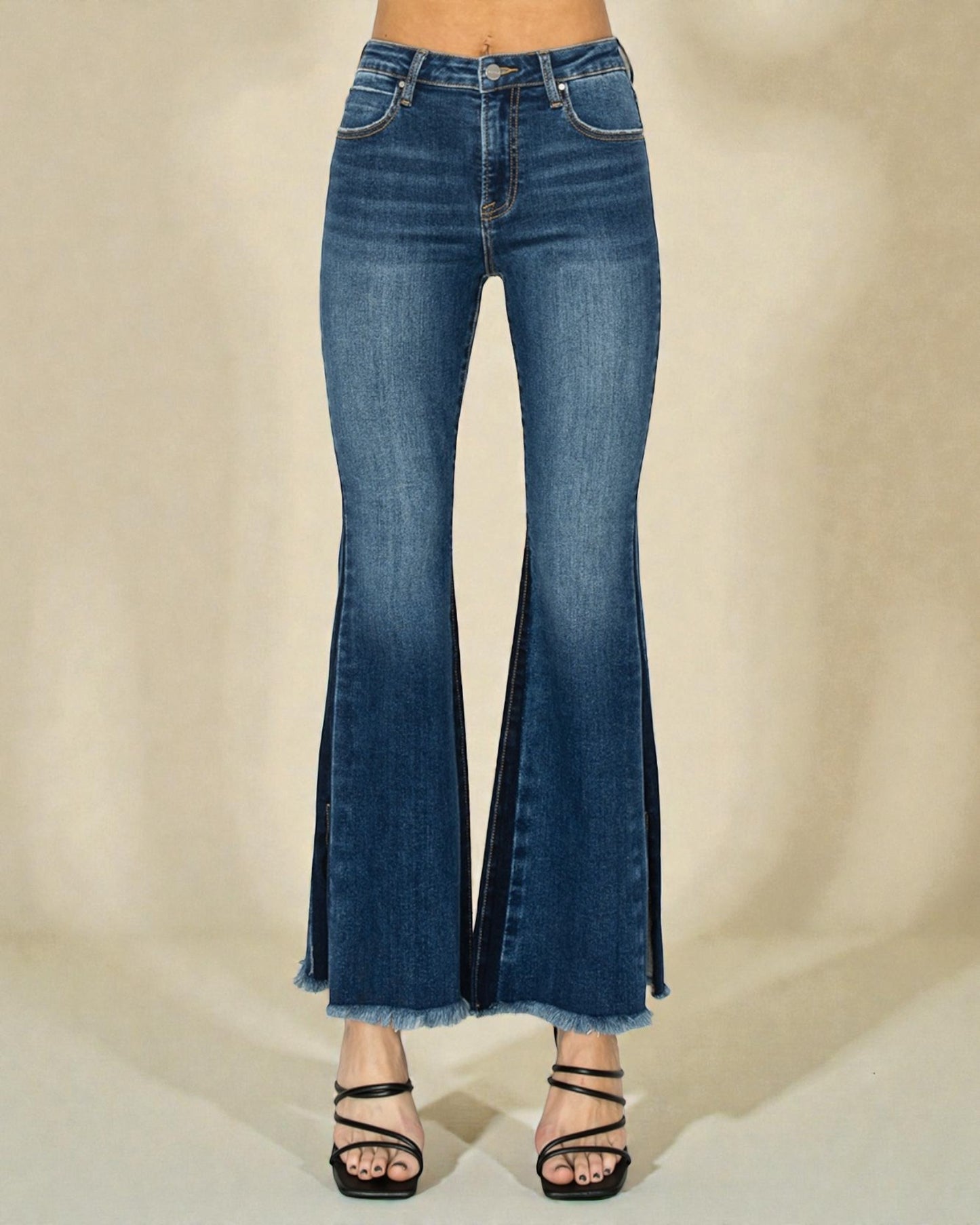 Flared blue jeans on a neutral background