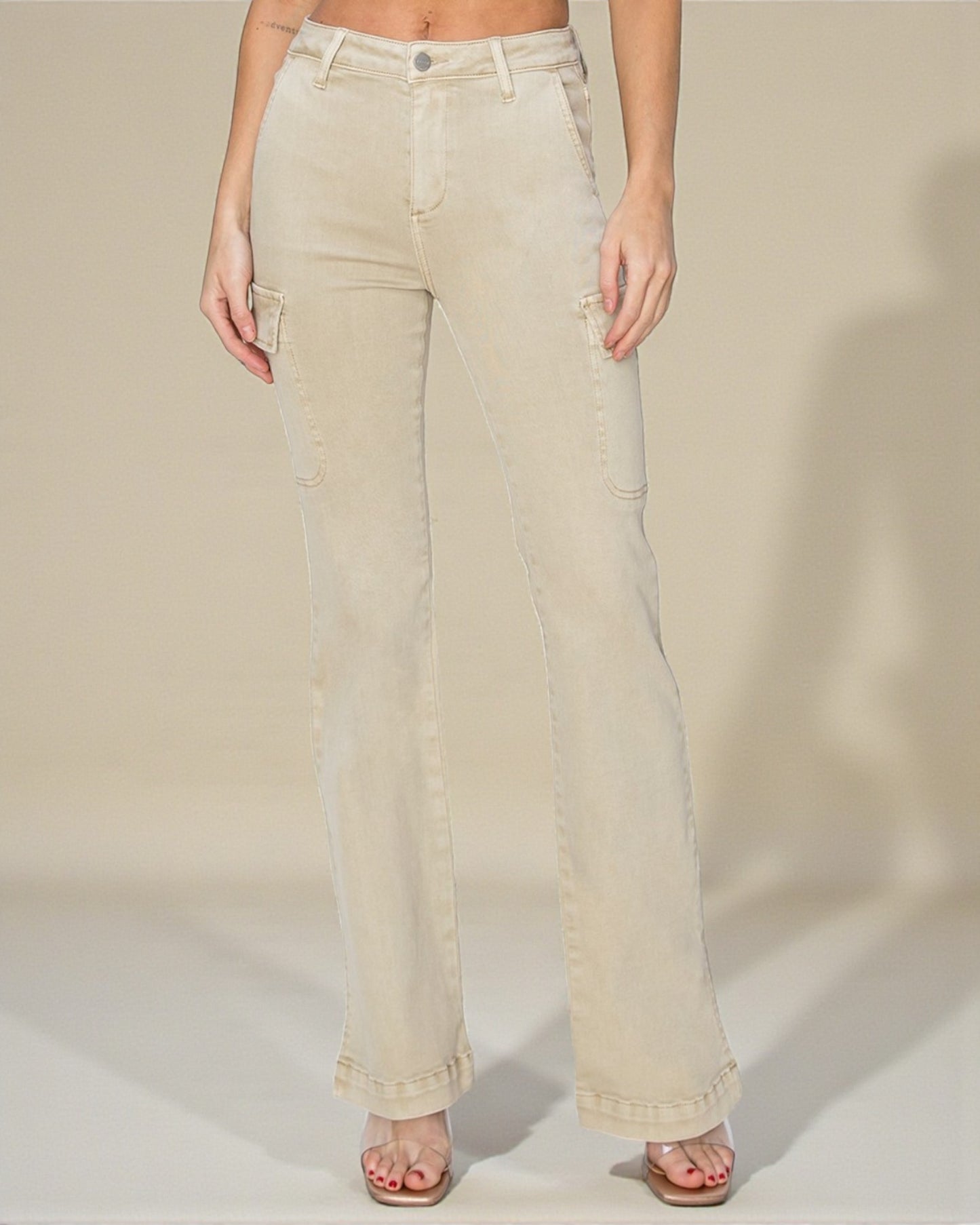 Beige jeans worn by a person on a plain background