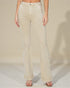 Beige jeans worn by a person on a plain background