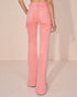 Pink jeans worn by a person on a beige background
