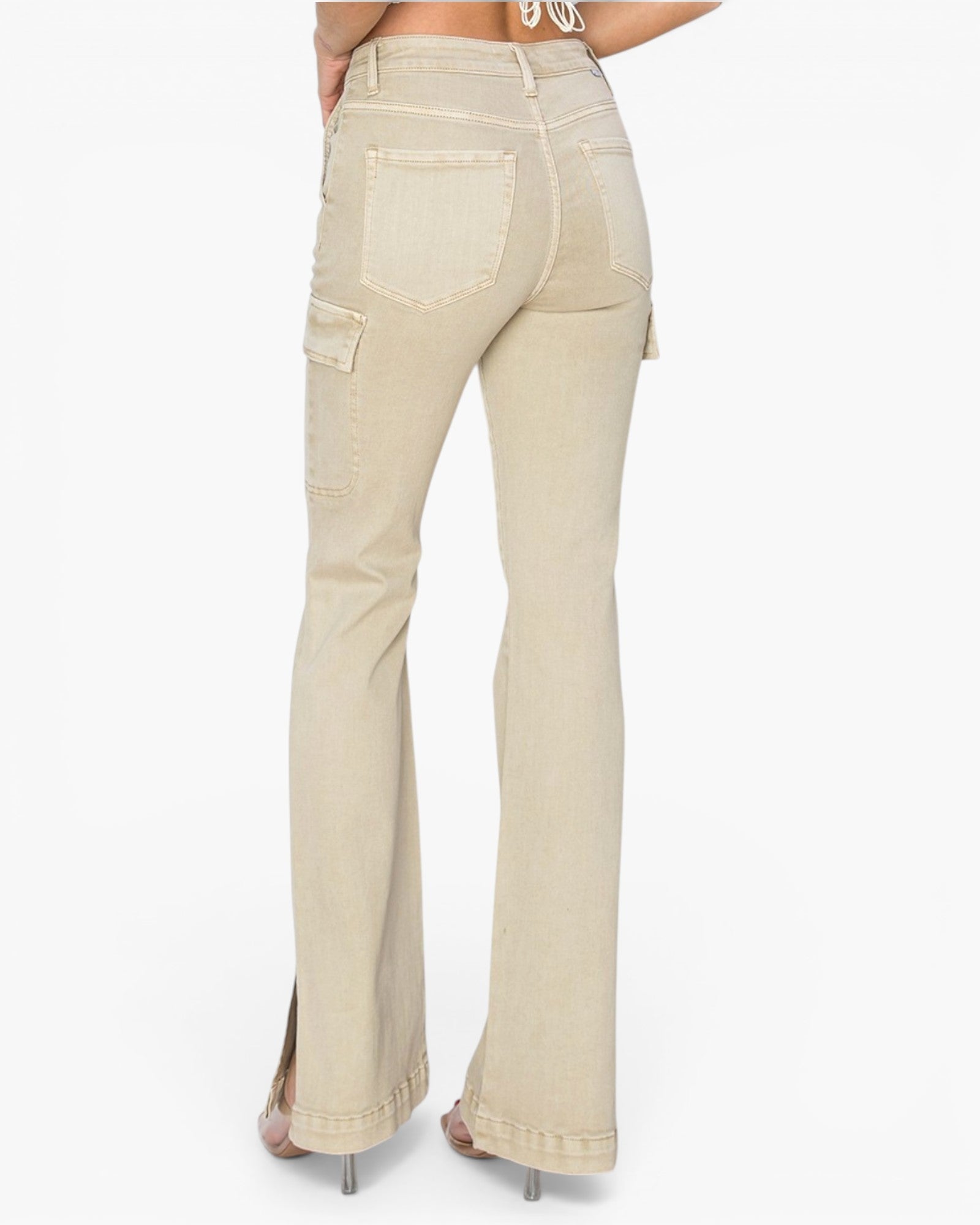Rear view of a model wearing light beige flared jeans with side cargo pockets, shown against a plain white studio background.