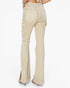 Rear view of a model wearing light beige flared jeans with side cargo pockets, shown against a plain white studio background.