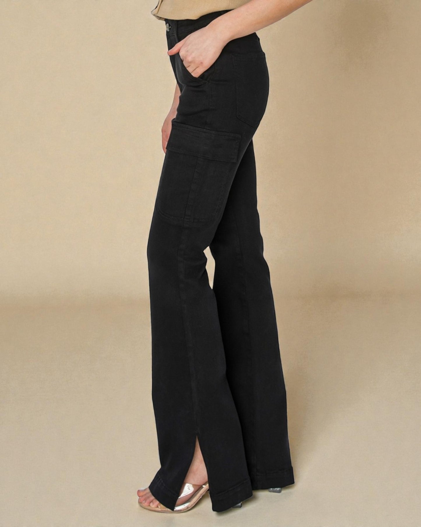 Black wide-leg pants worn by a person on a beige background
