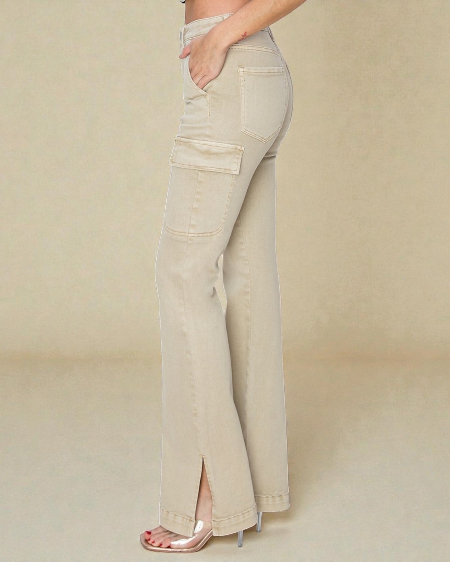 Beige flared jeans worn by a person on a beige background