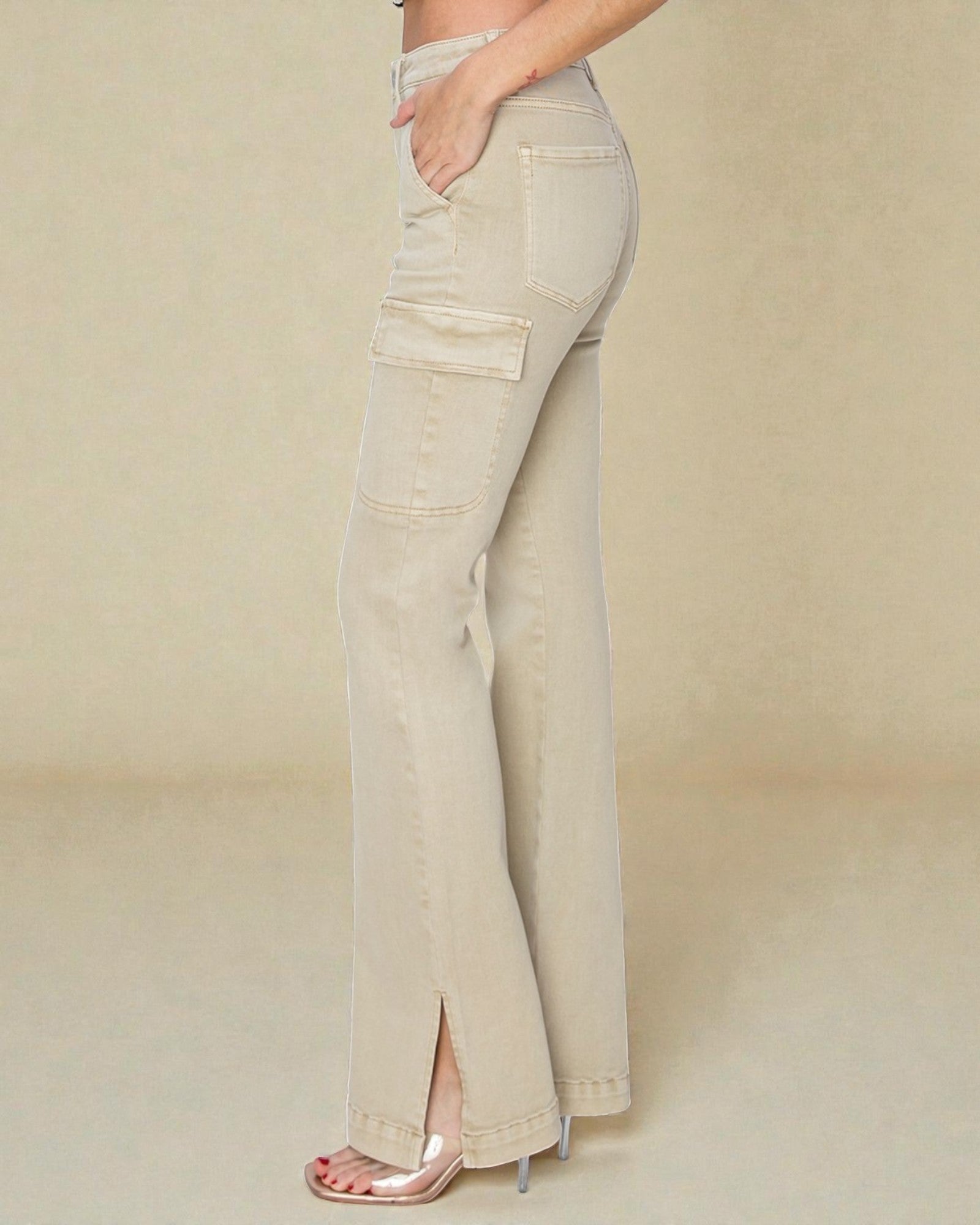 Beige flared jeans worn by a person on a beige background