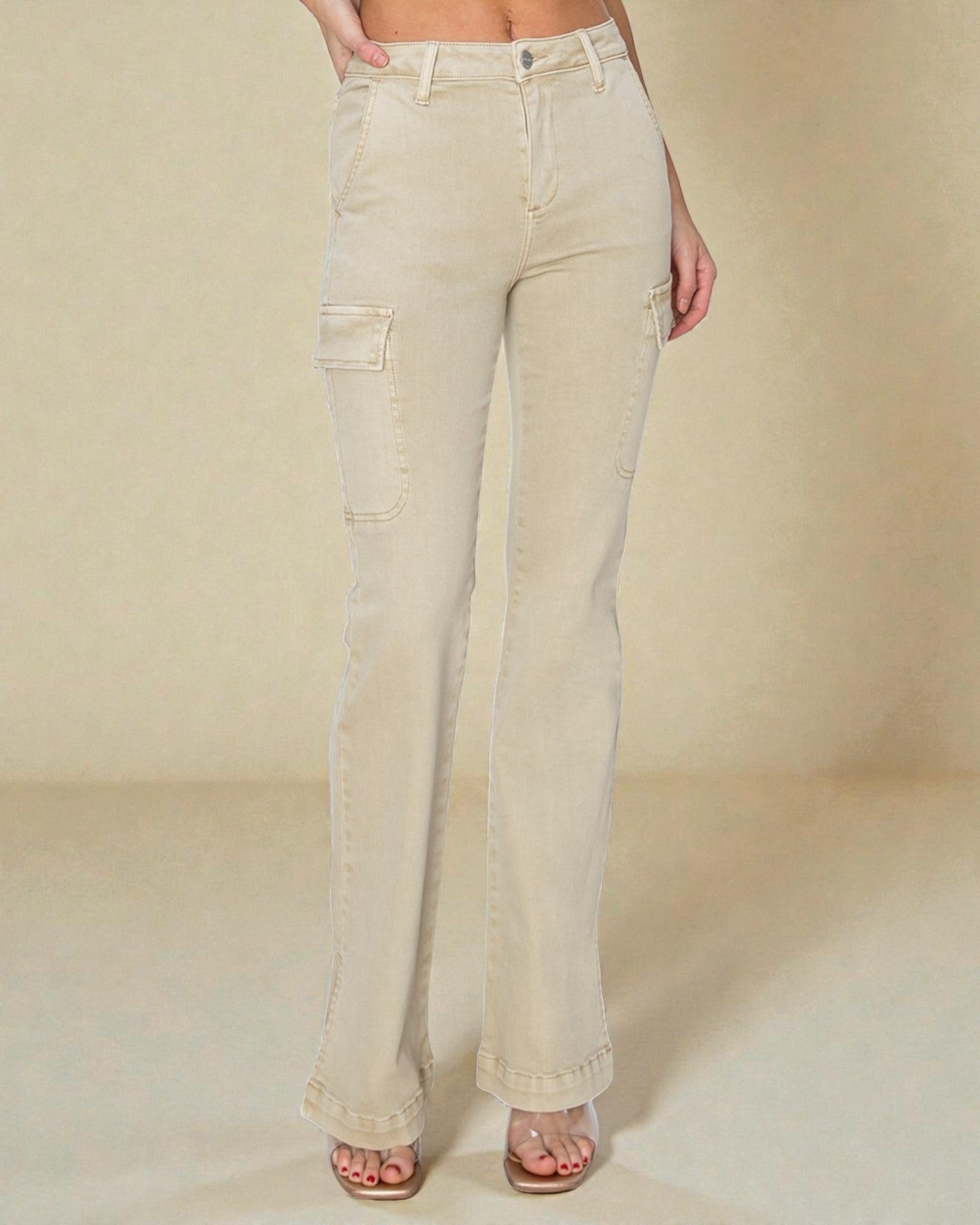 Beige jeans worn by a person on a plain background