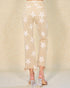Beige pants with star pattern worn by a person on a beige background