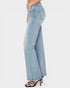 Light blue flared jeans worn by a person on a white background