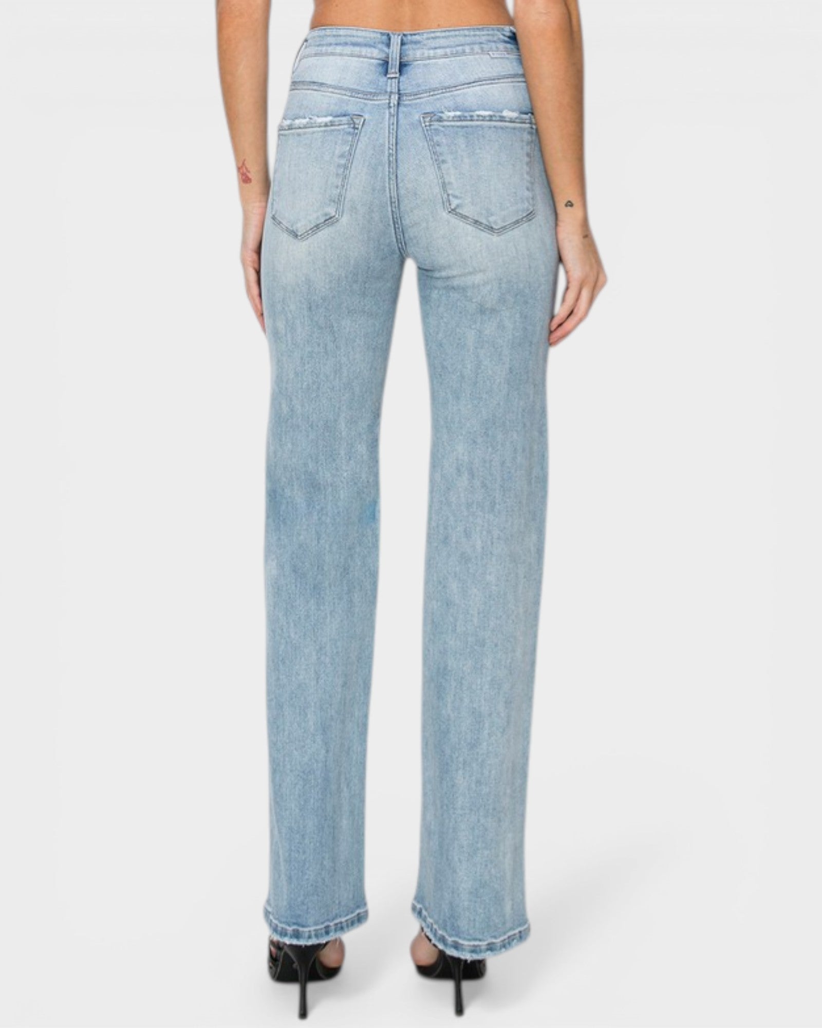 Light blue jeans worn by a person on a white background