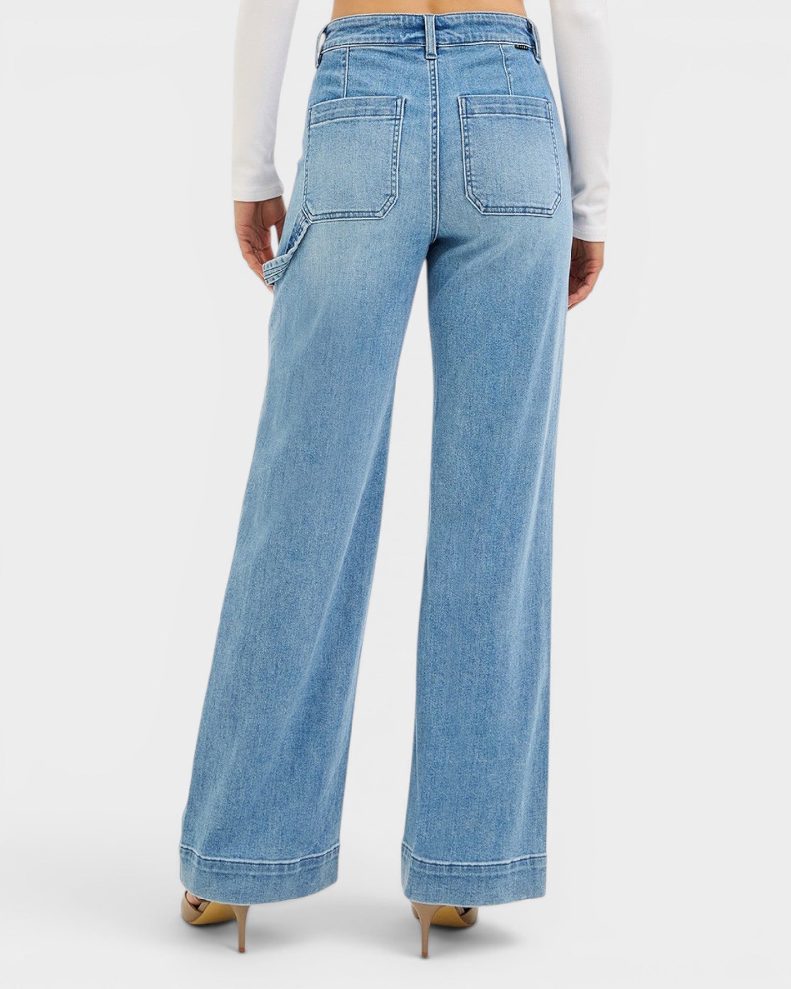 Light blue wide-leg jeans worn by a person on a white background