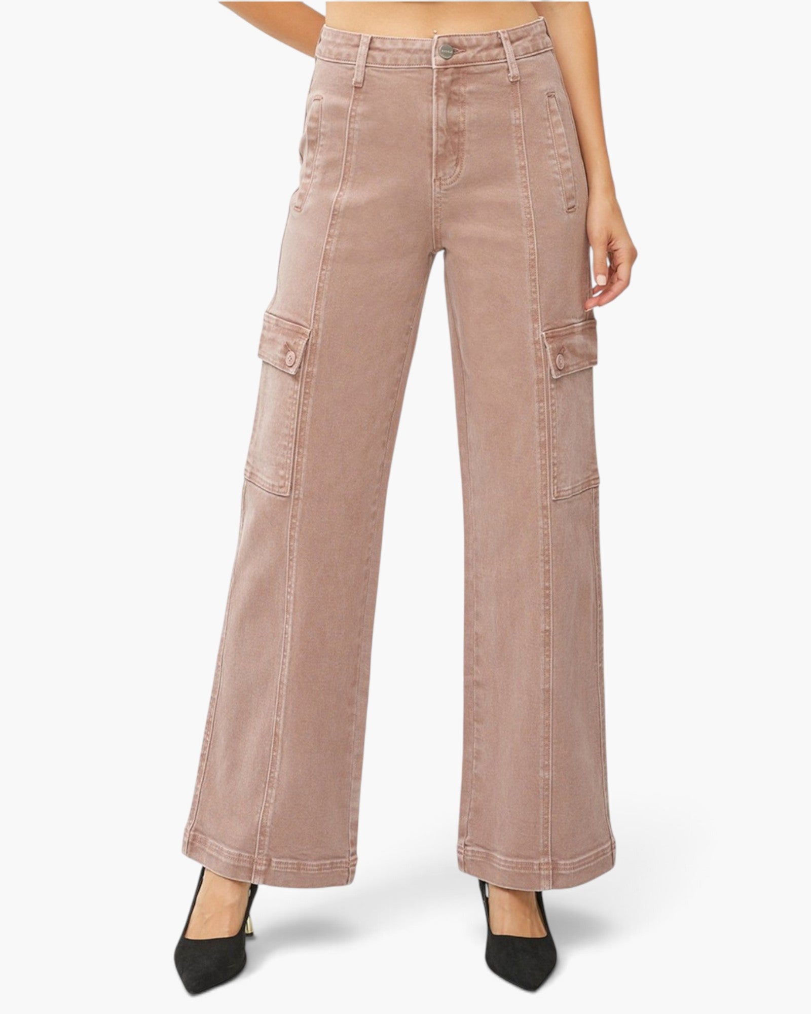 A model wearing dusty rose wide-leg cargo pants with black pointed-toe heels, shown from the waist down on a light gray studio background.