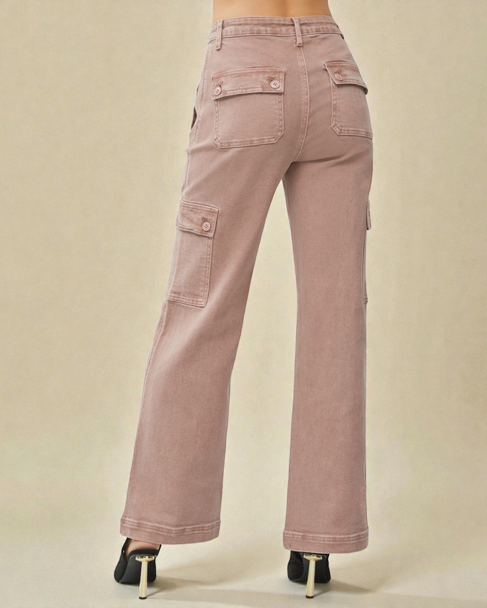 Pink cargo pants on a beige background
