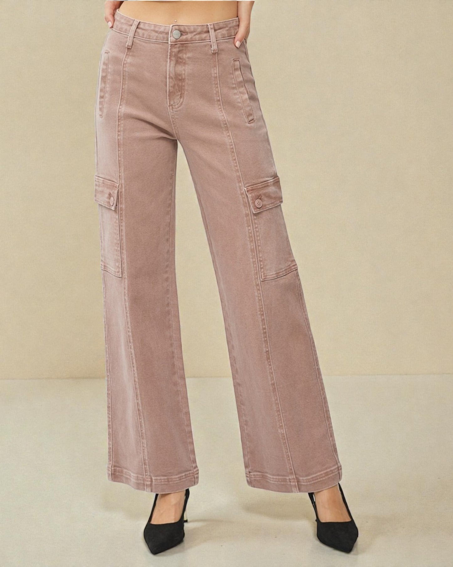 Pink cargo pants on a beige background