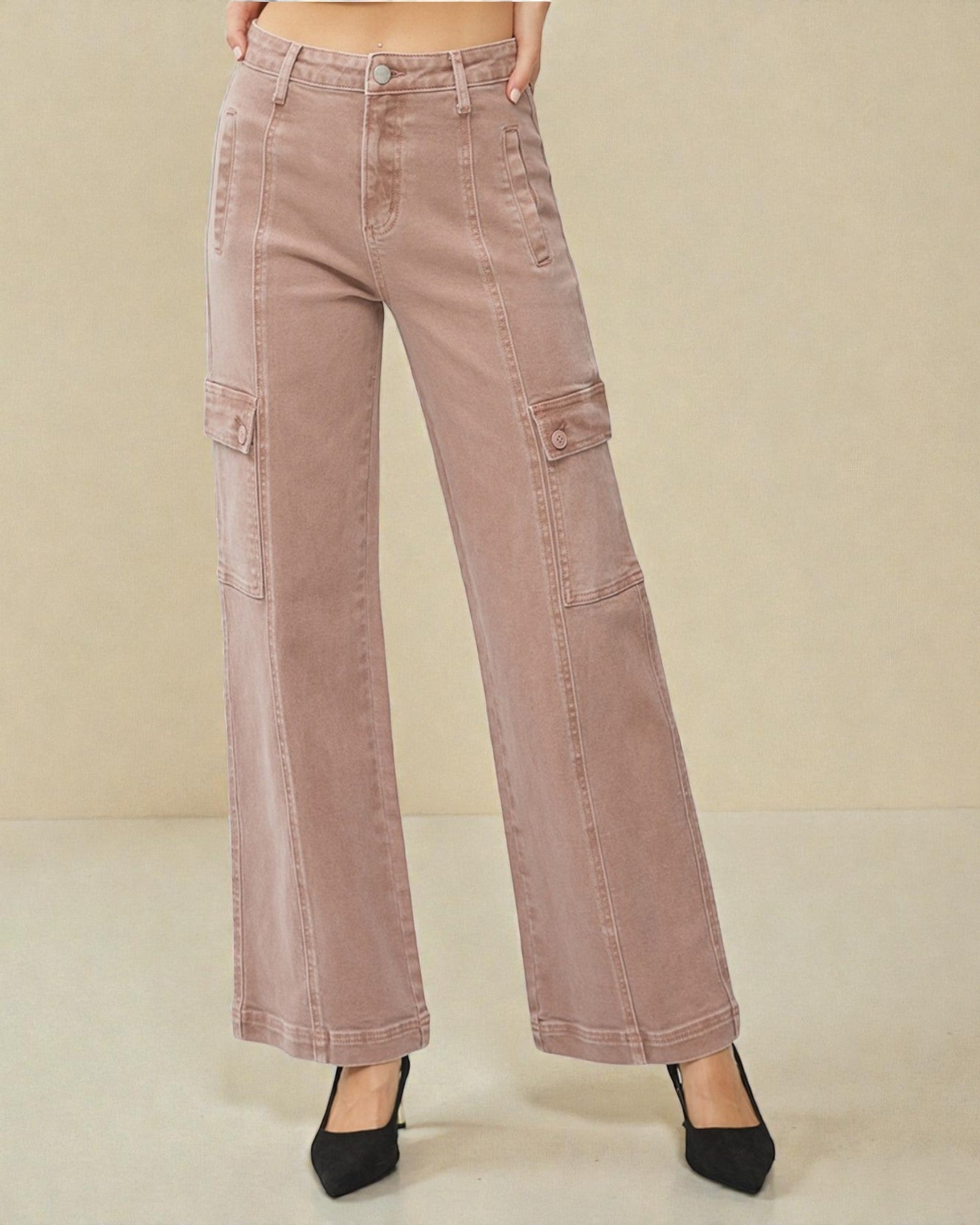 Pink cargo pants on a beige background