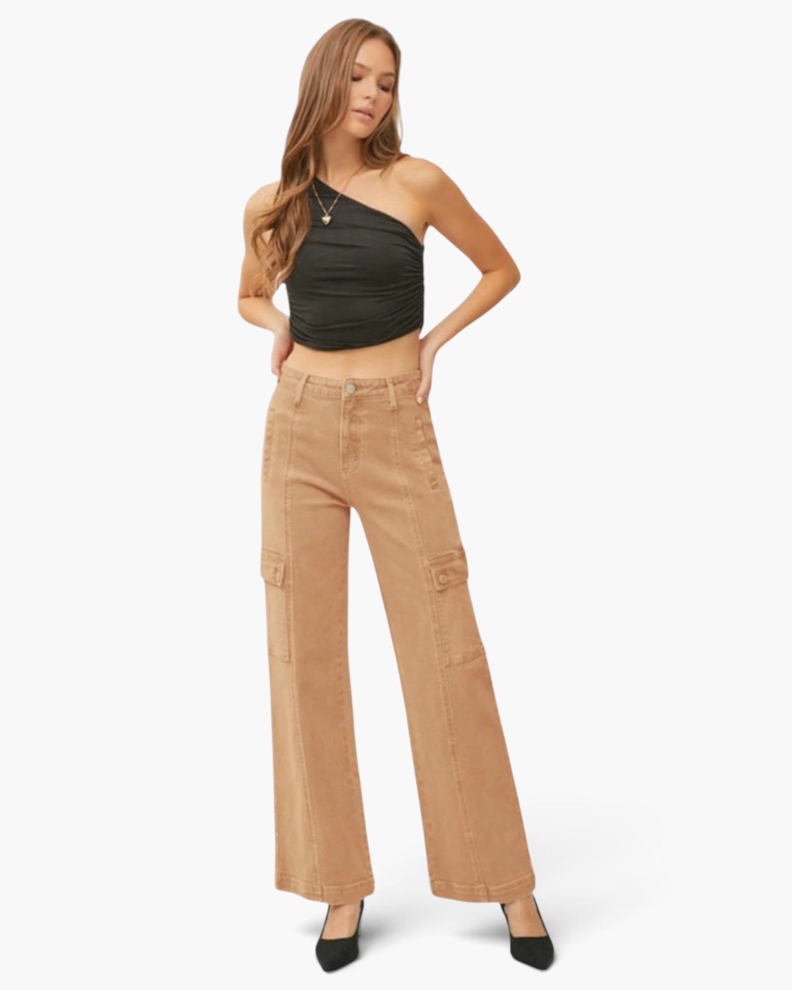 A woman modeling a black one-shoulder crop top and tan wide-leg cargo pants against a plain white studio background.