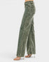 Green jeans worn by a person on a white background