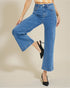 Person wearing blue wide-leg jeans on a beige background