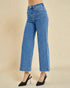 Blue jeans worn by a person on a beige background