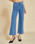 Person wearing blue jeans on a beige background
