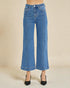 Blue jeans worn by a person on a beige background