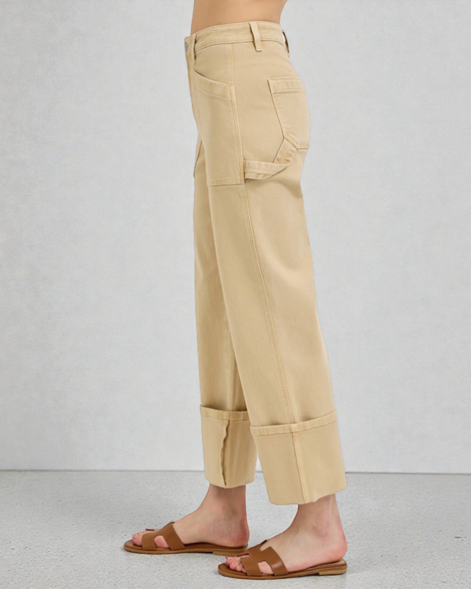 Beige pants worn by a person on a plain background
