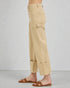 Beige pants worn by a person on a plain background