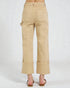 Beige pants worn by a person on a white background
