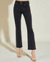 Black distressed jeans worn by a person on a neutral background