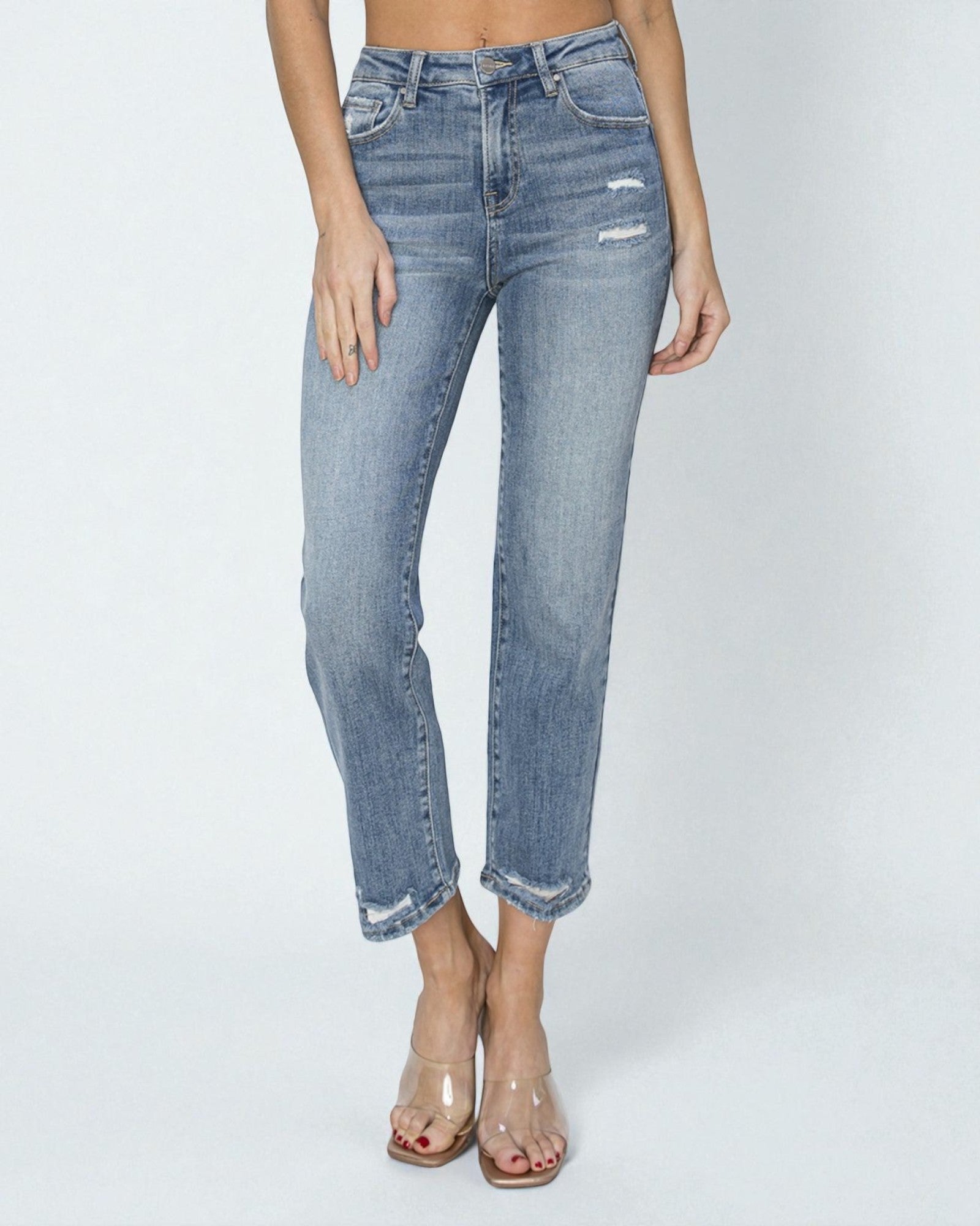 Light blue jeans worn by a person on a white background