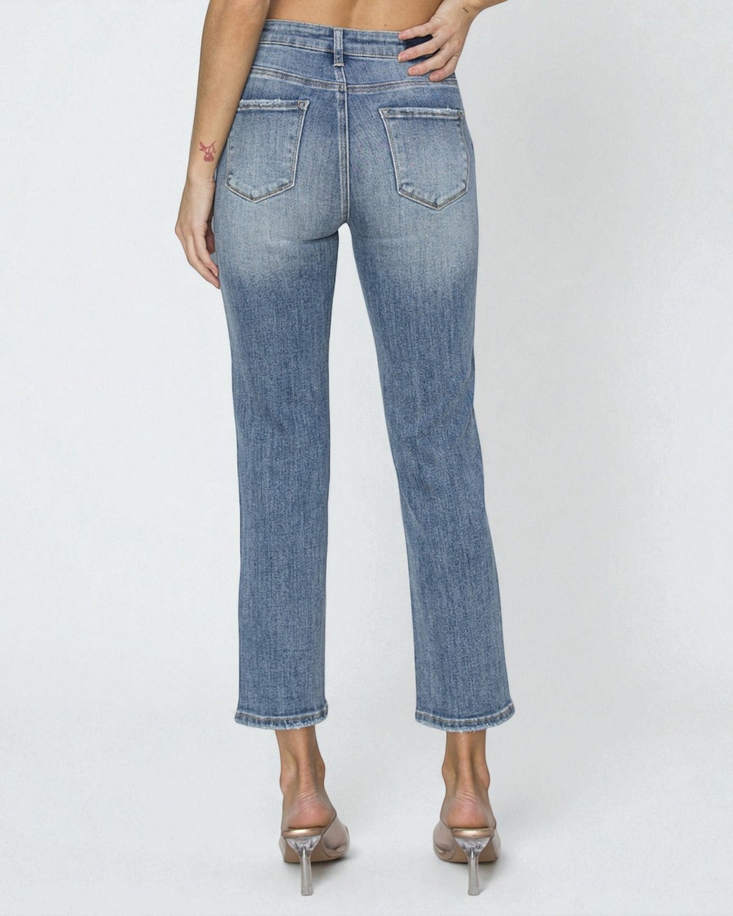 Blue jeans worn by a person on a white background