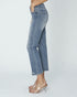 Person wearing blue jeans on a plain background