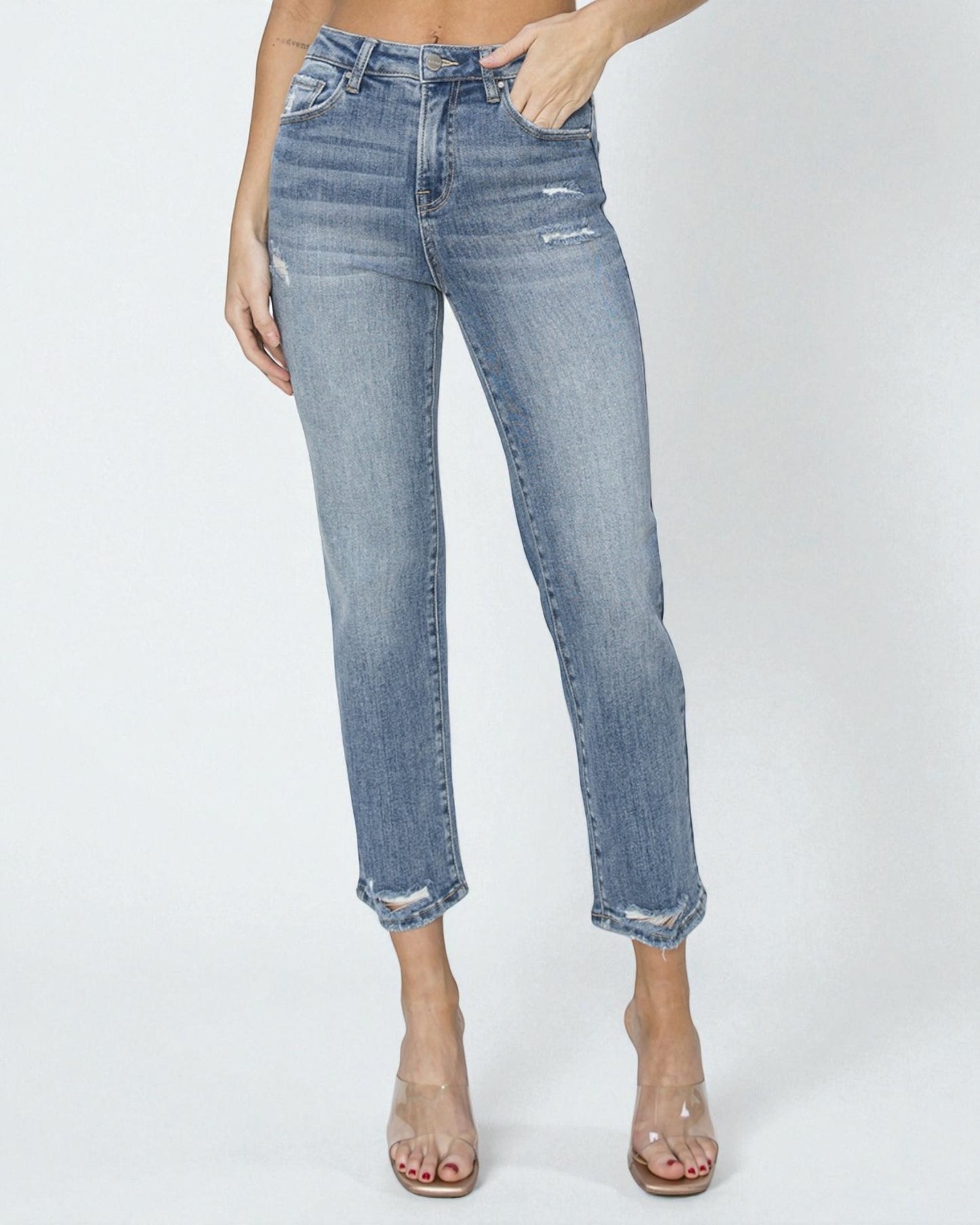 Person wearing light blue jeans on a white background