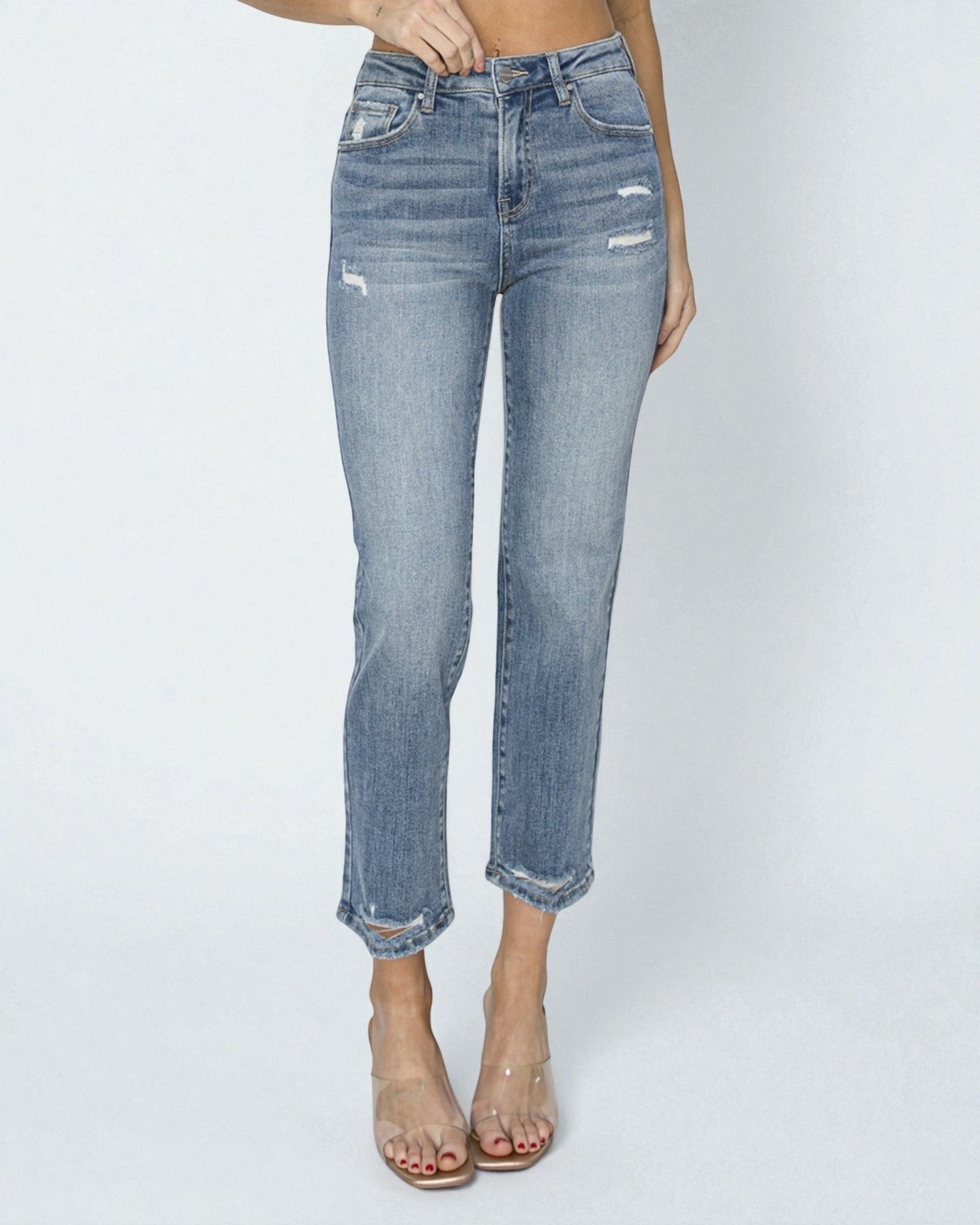 Light blue jeans worn by a person on a white background