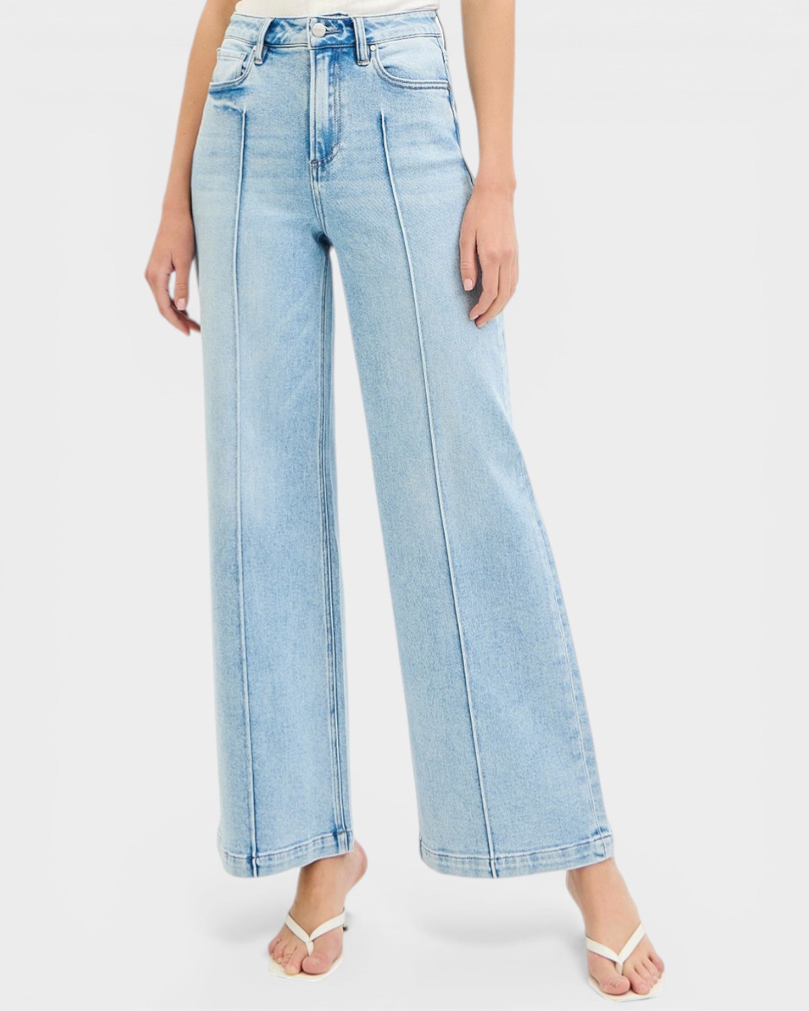 Light blue jeans worn by a person on a white background