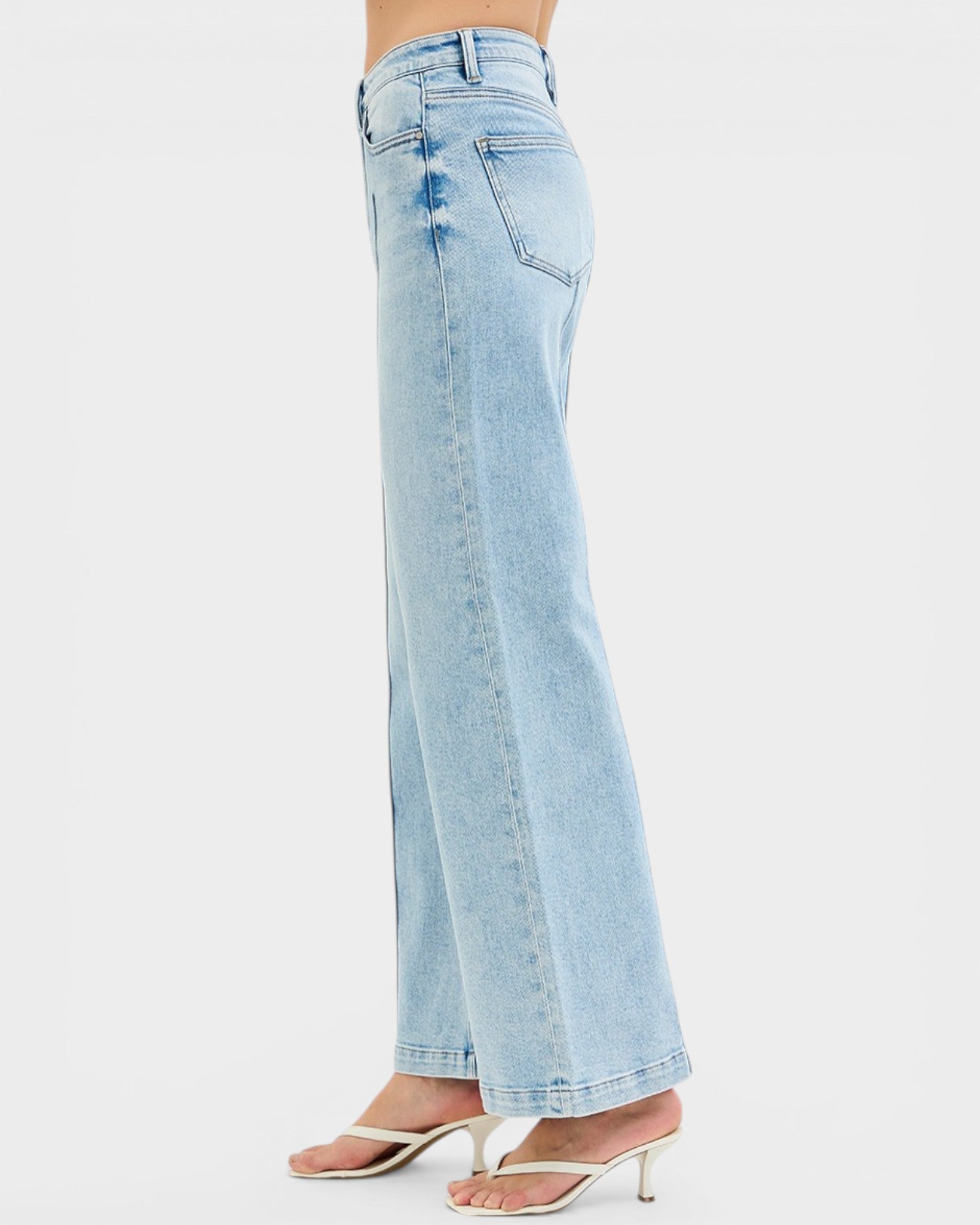 Light blue jeans worn by a person on a white background