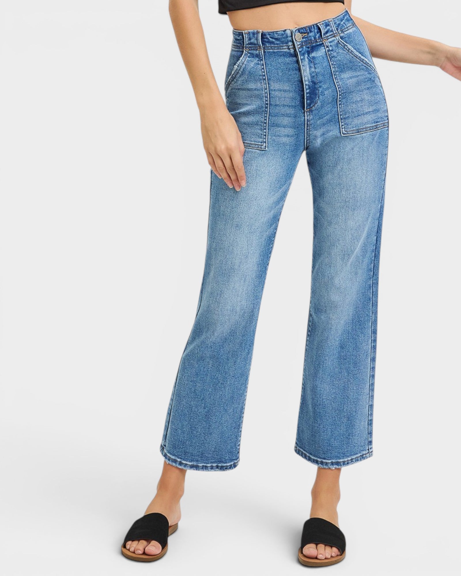 Blue jeans worn by a person on a white background