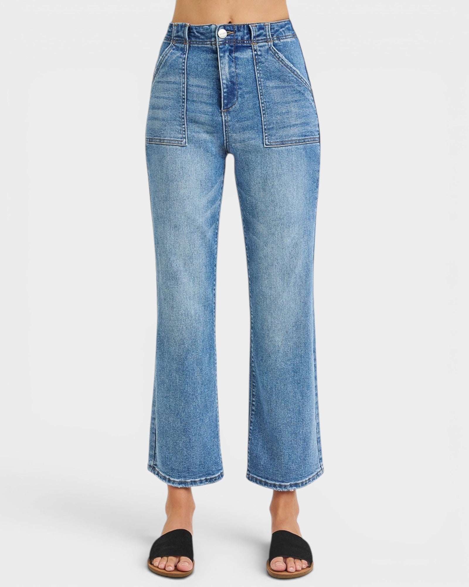 Blue jeans worn by a person on a white background