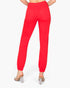 Red jogger-style pants with elastic cuffs and back pockets, shown on a model from the back against a light gray background.