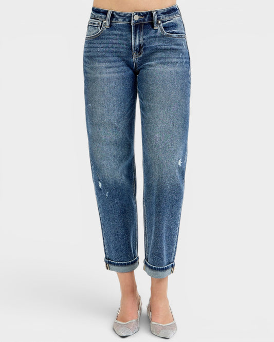 Blue jeans worn by a person on a white background