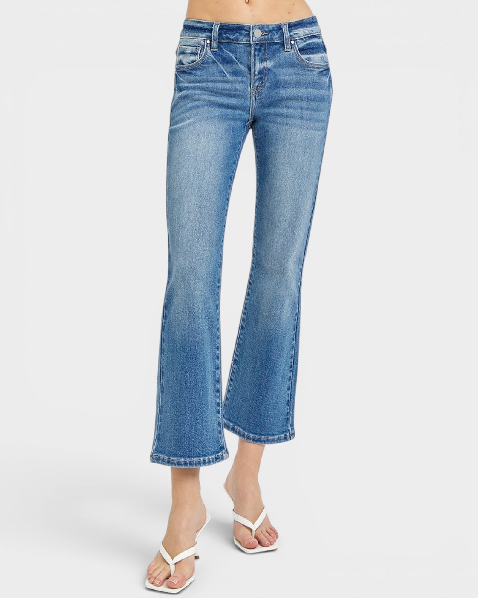 Blue jeans worn by a person on a white background