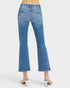 Blue jeans worn by a person on a white background
