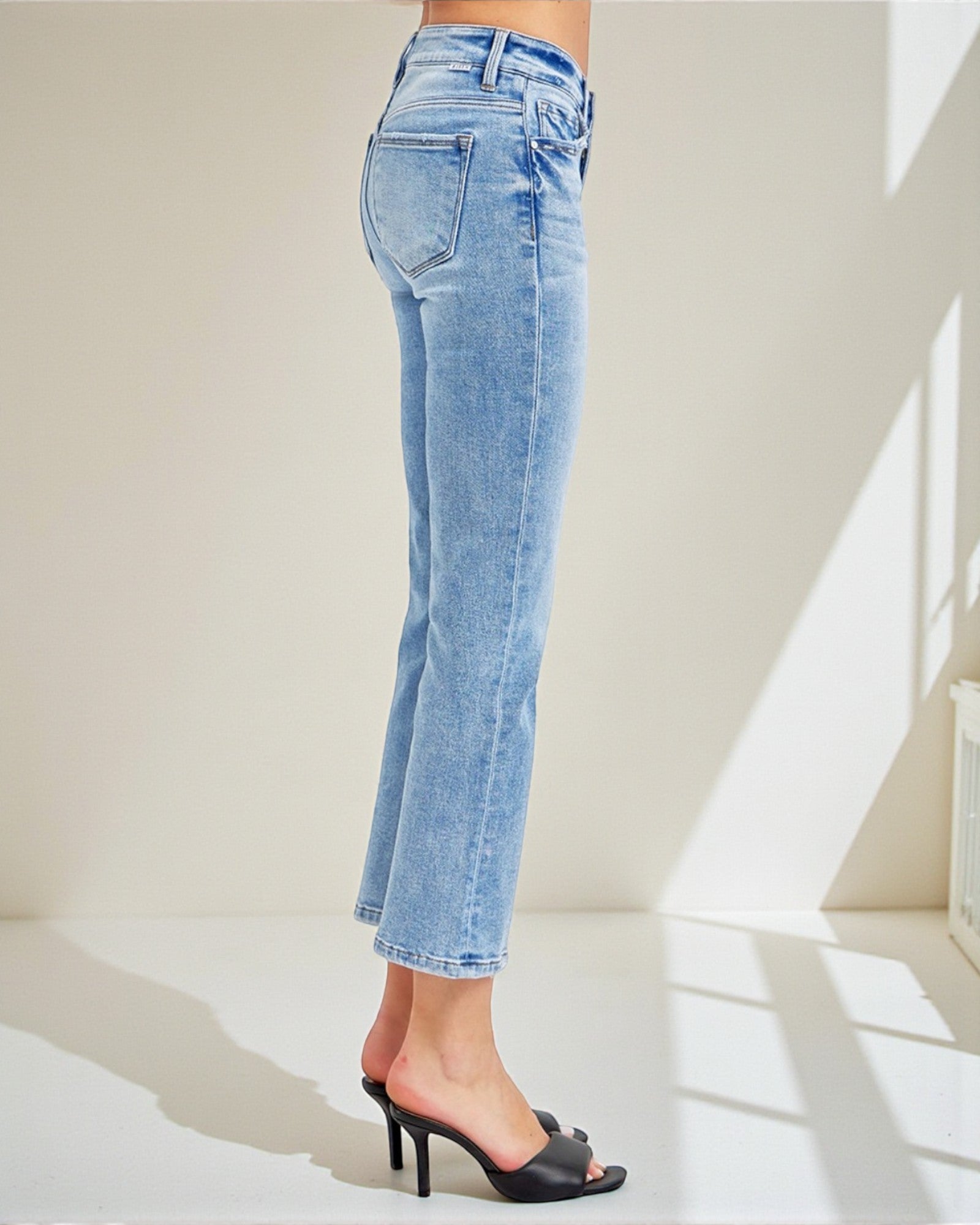 Light blue jeans worn by a person on a white background