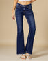 Blue jeans worn by a person on a beige background