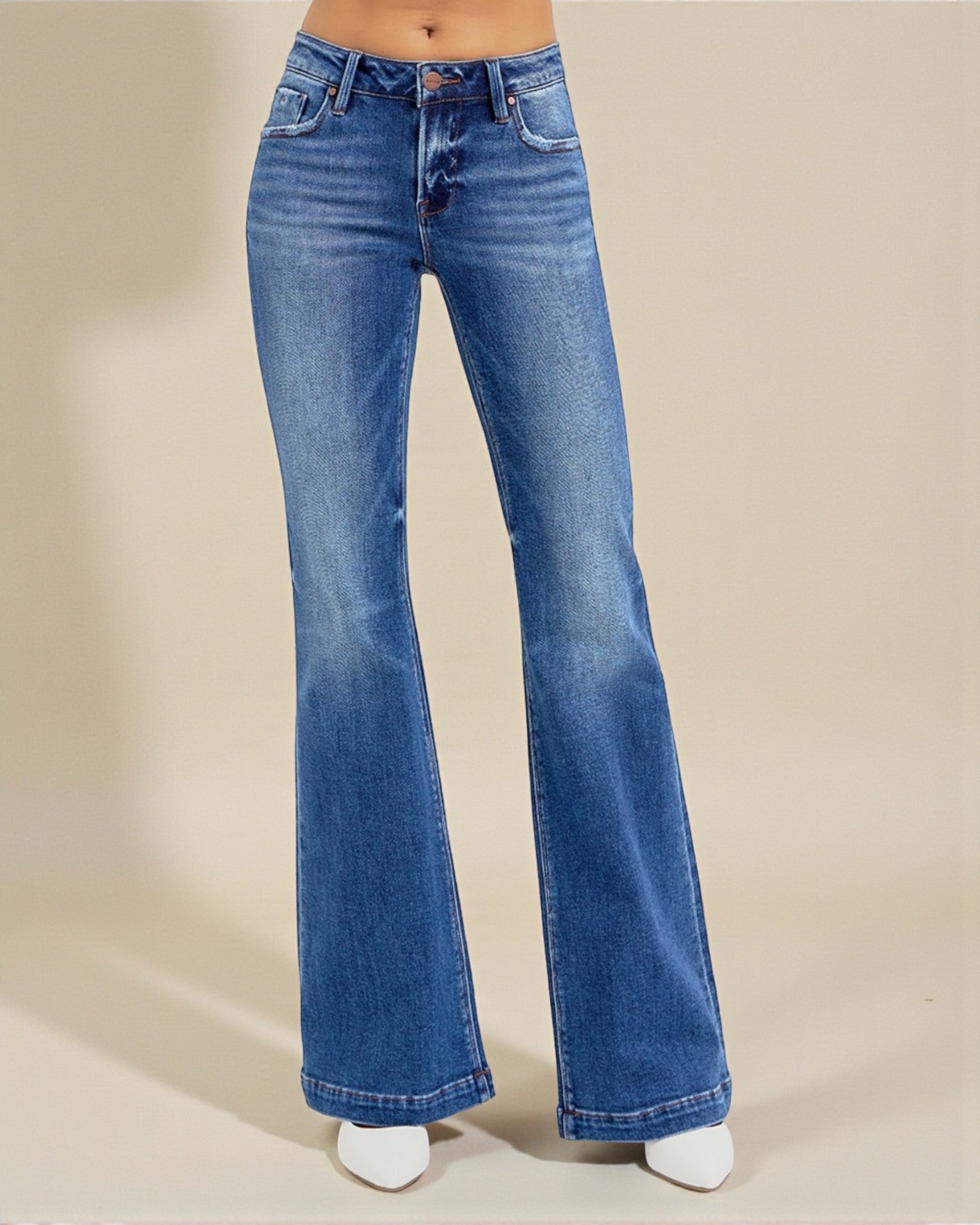 Blue flared jeans on a beige background