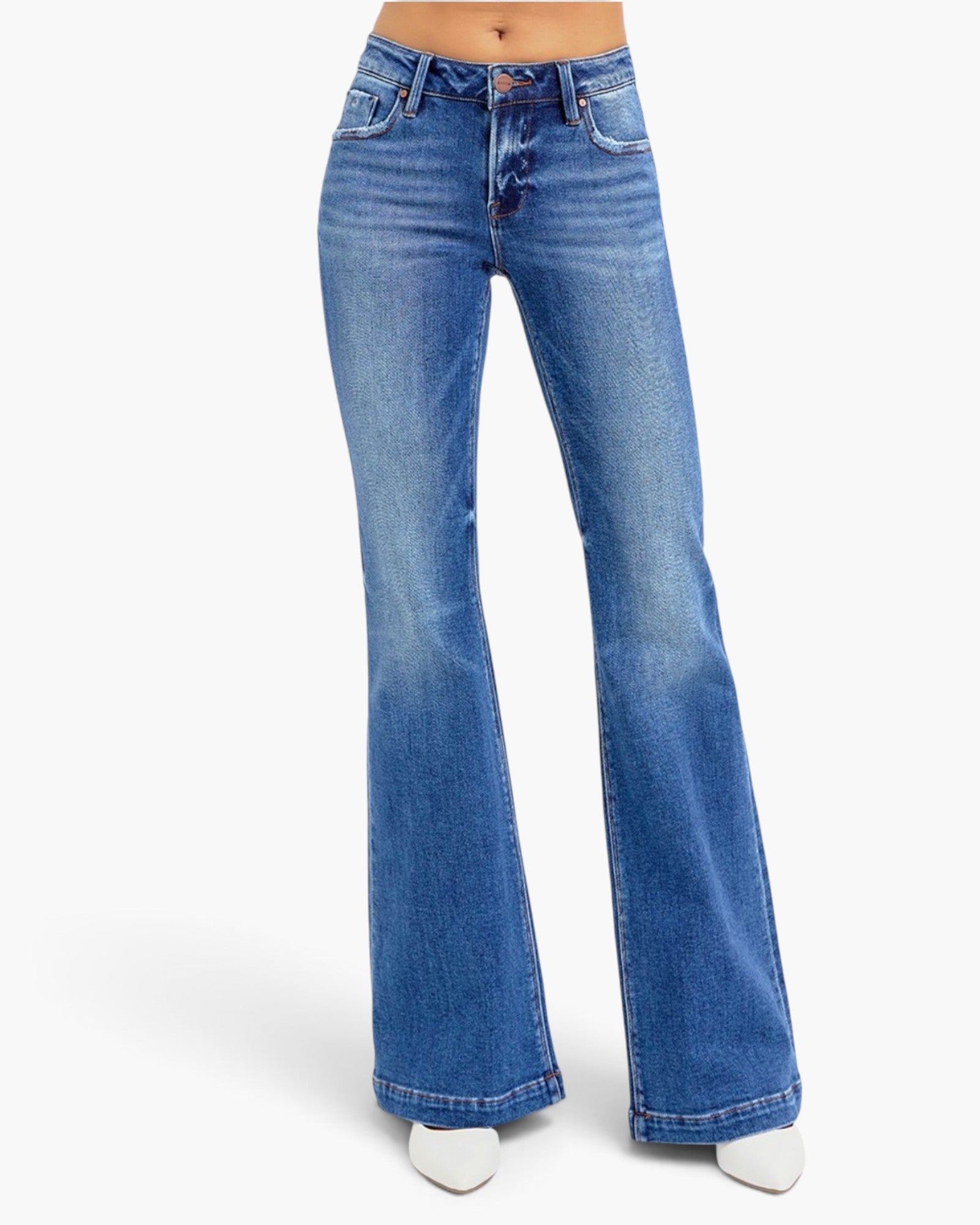 A pair of medium-wash blue denim flare jeans worn by a model, shown from the waist down on a clean white studio background.