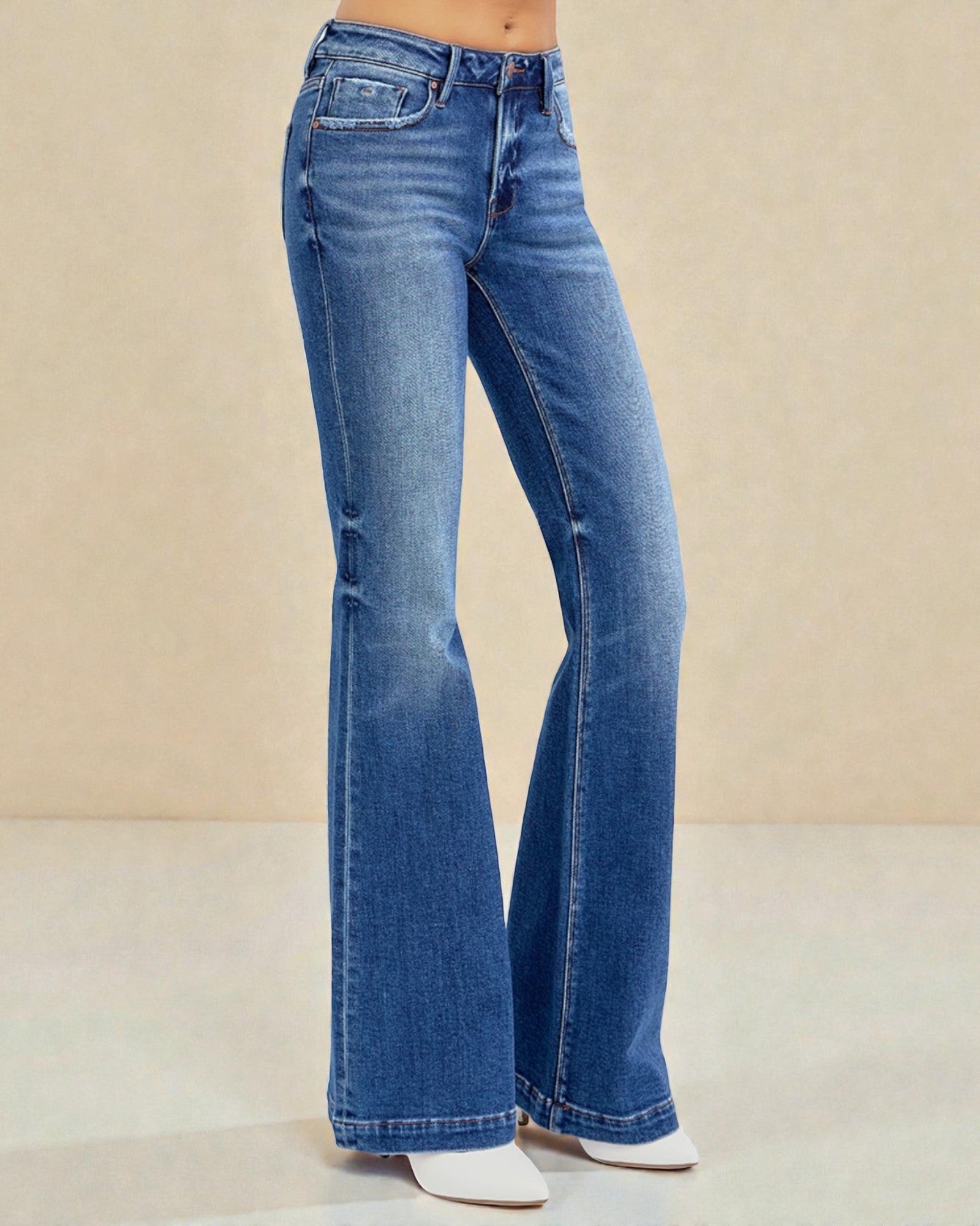 Blue flared jeans on a beige background